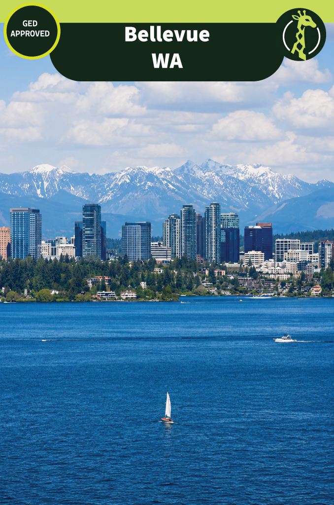 The Bellevue, Washington skyline seen across Lake Washington on a clear day, with a sailboat on the water and the snow-capped Cascade Range rising behind the city.