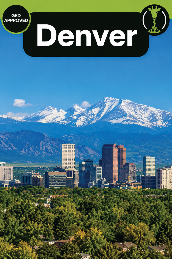 The downtown Denver skyline with the snow-covered Front Range of the Rocky Mountains behind it.