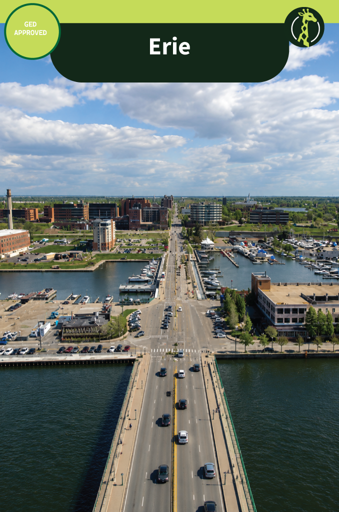 A road bridge crossing Presque Isle Bay into downtown Erie, Pennsylvania on a bright day, with marinas full of moored boats on either side.