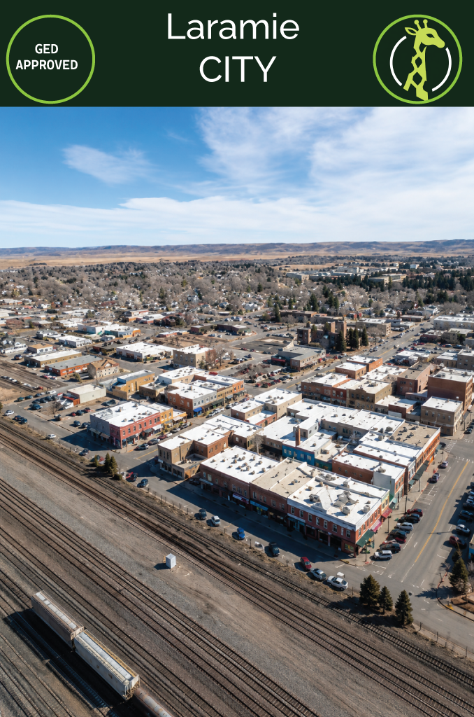 Historic brick storefronts in downtown Laramie, Wyoming, with the Snowy Range beyond.