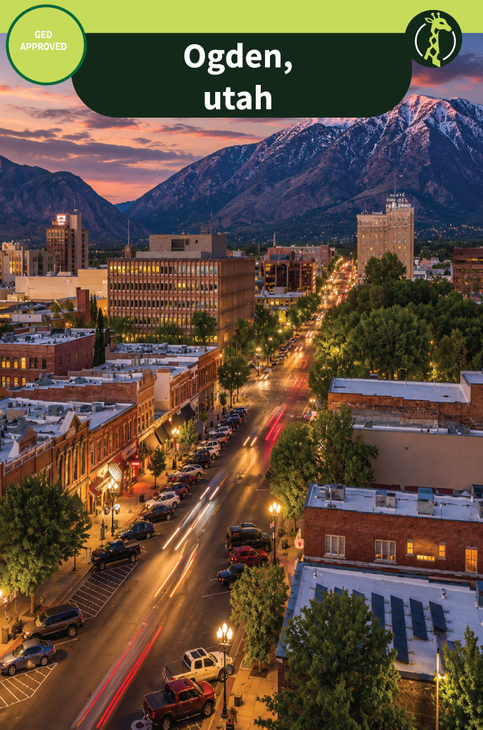 Historic 25th Street in Ogden, Utah, with the Wasatch Range rising behind the brick storefronts.