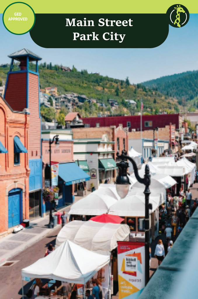 The historic Main Street of Old Town Park City, Utah, with ski runs on the mountainside above.